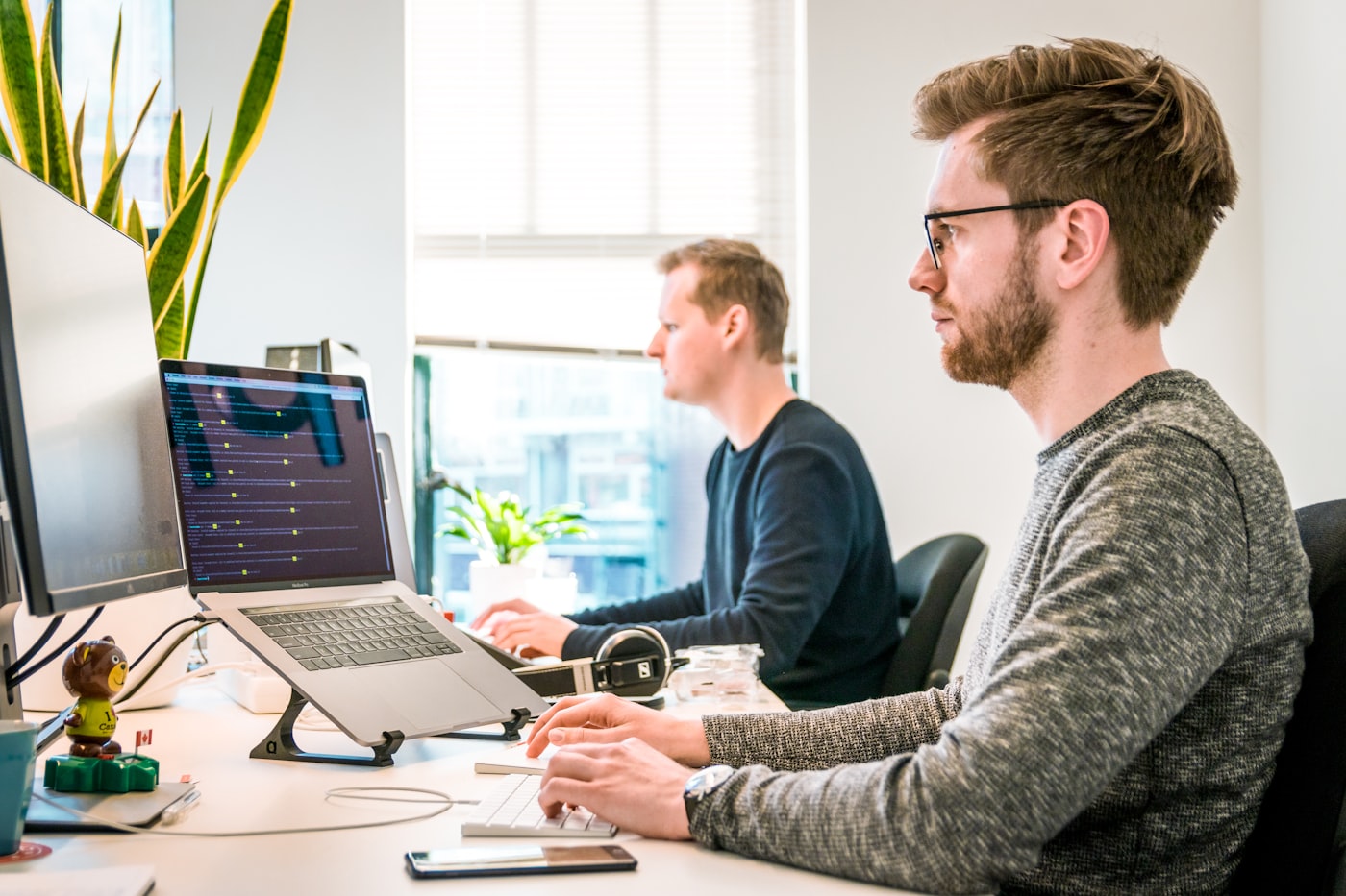 Professional software team collaborating in a modern office